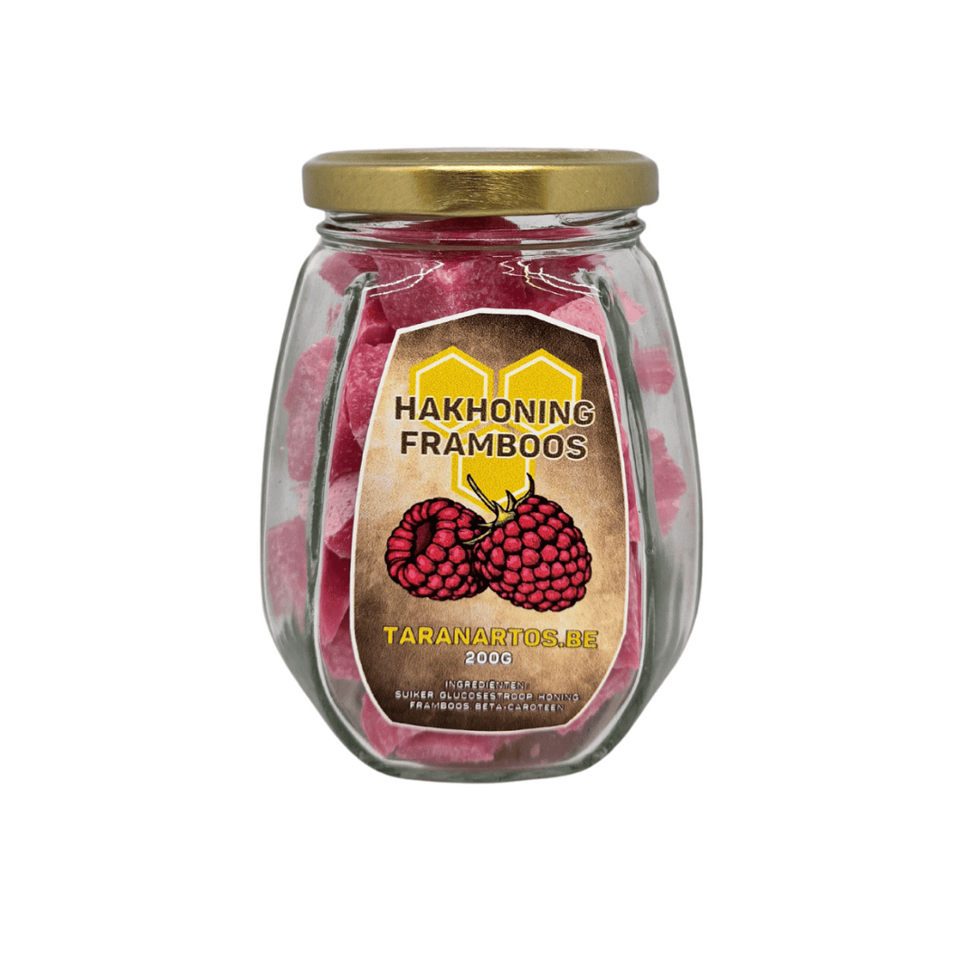 Zoete framboos-honing snoepjes in een glazen pot met gouden deksel, puur natuur en handgemaakt, perfect als lekkernij of cadeau, verkrijgbaar bij Taranartos.be.